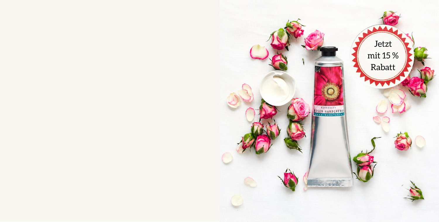 silberne Handcreme Tube Rosenduft auf weißem Hintergrund mit Rosenknospen umringt. Sonnenförmiger Störer mit 15% Rabatt. 